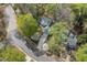 An aerial view showing a home with mature trees and well-maintained landscaping nestled on a quiet street at 1550 Pathway Dr, Carrboro, NC 27510