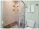 Modern bathroom showing a tiled shower with seamless glass door and a toilet with green walls at 1550 Pathway Dr, Carrboro, NC 27510