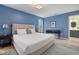 Well-lit bedroom with blue walls, comfortable bed, and coordinated decor at 1550 Pathway Dr, Carrboro, NC 27510