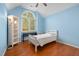 Spacious bedroom boasts hardwood floors, an arched window, and a white bookcase at 1550 Pathway Dr, Carrboro, NC 27510