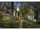 Charming exterior of a well-maintained home with a lush landscaped front yard and inviting brick walkway at 1550 Pathway Dr, Carrboro, NC 27510