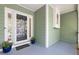 Inviting front porch area showcasing potted flowers and a stylish front door at 1550 Pathway Dr, Carrboro, NC 27510