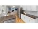 Open kitchen view with stainless steel fridge, white cabinets, and view to the cozy living room at 1550 Pathway Dr, Carrboro, NC 27510