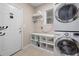 Functional laundry room with washer, dryer, and shelving for storage at 1550 Pathway Dr, Carrboro, NC 27510