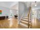Bright open-concept living space with hardwood floors, stairs, and large windows at 1550 Pathway Dr, Carrboro, NC 27510