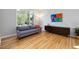 Well-lit living room with hardwood floors, large windows, and neutral decor at 1550 Pathway Dr, Carrboro, NC 27510