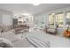 Spacious living room connecting to the kitchen, filled with natural light and comfortable furnishings at 1550 Pathway Dr, Carrboro, NC 27510