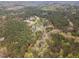 Beautiful aerial view of a wooded neighborhood with ponds and mature trees, offering a serene landscape at 160 Sweet Pine Cir, Pittsboro, NC 27312