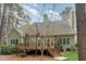 Rear view of home featuring a spacious deck and mature landscaping at 160 Sweet Pine Cir, Pittsboro, NC 27312