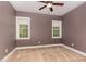 Neutral bedroom featuring two windows and a ceiling fan at 160 Sweet Pine Cir, Pittsboro, NC 27312