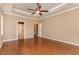 Spacious bedroom with large windows and tray ceiling with fan at 160 Sweet Pine Cir, Pittsboro, NC 27312