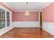 Dining room with decorative chandelier, wainscotting and large window at 160 Sweet Pine Cir, Pittsboro, NC 27312