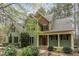 Charming two-story home boasts lush landscaping, a welcoming front porch, and a well-maintained green lawn at 160 Sweet Pine Cir, Pittsboro, NC 27312