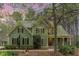Charming two-story home boasts lush landscaping, a welcoming front porch, and a well-maintained green lawn at 160 Sweet Pine Cir, Pittsboro, NC 27312
