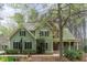 Charming two-story home boasts lush landscaping, a welcoming front porch, and a well-maintained green lawn at 160 Sweet Pine Cir, Pittsboro, NC 27312