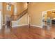 Bright and open living room showcasing hardwood floors, a staircase, and seamless flow to other spaces at 160 Sweet Pine Cir, Pittsboro, NC 27312