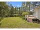 Spacious backyard with lush greenery, a deck, and room for outdoor activities at 163 Ridge Way Ln, Clayton, NC 27520