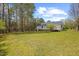 Expansive backyard featuring a well-maintained lawn and a charming deck area at 163 Ridge Way Ln, Clayton, NC 27520