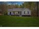 Inviting home with a manicured lawn, cozy porch, and vibrant blue details enhancing its curb appeal at 163 Ridge Way Ln, Clayton, NC 27520