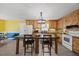 Eat-in kitchen features wood cabinets, modern appliances, and a central island with seating at 163 Ridge Way Ln, Clayton, NC 27520