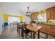 Open concept kitchen featuring custom wood cabinets, an island, and ample dining space at 163 Ridge Way Ln, Clayton, NC 27520