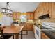 Open-concept kitchen with wooden cabinetry, stone countertops, and modern appliances at 163 Ridge Way Ln, Clayton, NC 27520