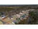 An aerial view of a residential neighborhood surrounded by lush green trees and landscaping on a sunny day at 201 W Amber Oak Drive, Selma, NC 27576