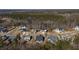 An aerial view of a residential neighborhood surrounded by lush green trees and landscaping on a sunny day at 201 W Amber Oak Drive, Selma, NC 27576