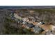 An aerial view of a residential neighborhood surrounded by lush green trees and landscaping on a sunny day at 201 W Amber Oak Drive, Selma, NC 27576