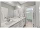 Bathroom features double sink vanity and doorway leading to toilet and shower at 201 W Amber Oak Drive, Selma, NC 27576