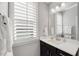 Elegant bathroom with white cabinets, shutters on the window, and neutral paint at 201 W Amber Oak Drive, Selma, NC 27576