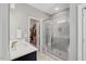Modern bathroom featuring a marble shower with glass doors and a spacious closet at 201 W Amber Oak Drive, Selma, NC 27576