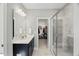 Bathroom featuring double sink vanity and doorway leading to walk-in closet and shower at 201 W Amber Oak Drive, Selma, NC 27576