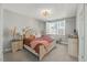 Cozy bedroom with a tufted headboard, soft bedding, and plenty of natural light from the window at 201 W Amber Oak Drive, Selma, NC 27576
