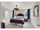 Comfortable bedroom with ample natural light, stylish lighting, and adjacent bath at 201 W Amber Oak Drive, Selma, NC 27576