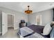 Bedroom featuring tv, chair and dresser with access to the bathroom and walk-in closet at 201 W Amber Oak Drive, Selma, NC 27576