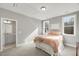 Bedroom with ensuite bathroom and two windows offering natural light at 201 W Amber Oak Drive, Selma, NC 27576