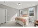 Sunlit bedroom offering two windows, plush carpet, and neutral walls at 201 W Amber Oak Drive, Selma, NC 27576