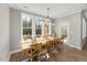 Bright dining area with a large window, wooden table, and stylish chairs, perfect for Gathering meals and gatherings at 201 W Amber Oak Drive, Selma, NC 27576