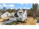 Charming home featuring white siding, black roof, two-car garage, complimented with well-manicured yard and driveway at 201 W Amber Oak Drive, Selma, NC 27576