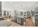 Bright, open-concept kitchen with island, granite countertops, and stainless steel appliances, leading to dining and living spaces at 201 W Amber Oak Drive, Selma, NC 27576