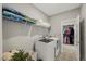 Well-organized laundry room with washer, dryer, and storage shelves for linens and laundry essentials at 201 W Amber Oak Drive, Selma, NC 27576