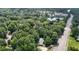 Aerial view of the home surrounded by lush trees, a nearby lake, and easy access to the highway at 207 High House Rd, Cary, NC 27513