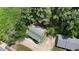 Aerial view of a log cabin home with a green roof nestled among mature trees at 207 High House Rd, Cary, NC 27513