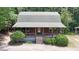 Aerial view of a charming log cabin, lush landscaping, and a private setting at 207 High House Rd, Cary, NC 27513