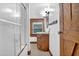 Bathroom featuring a shower with a glass door, a vintage wood vanity and an updated sink at 207 High House Rd, Cary, NC 27513