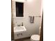 Cozy bathroom featuring a pedestal sink, mirrored medicine cabinet, and a convenient towel rack at 207 High House Rd, Cary, NC 27513