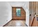 Charming bedroom with hardwood floors and a log wall accent, offering a rustic feel at 207 High House Rd, Cary, NC 27513