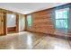 Spacious bedroom boasting hardwood floors, wood walls, and ample natural light from two windows at 207 High House Rd, Cary, NC 27513