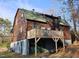 Rustic log cabin with a large deck overlooking the yard, offering a unique and charming living space at 207 High House Rd, Cary, NC 27513
